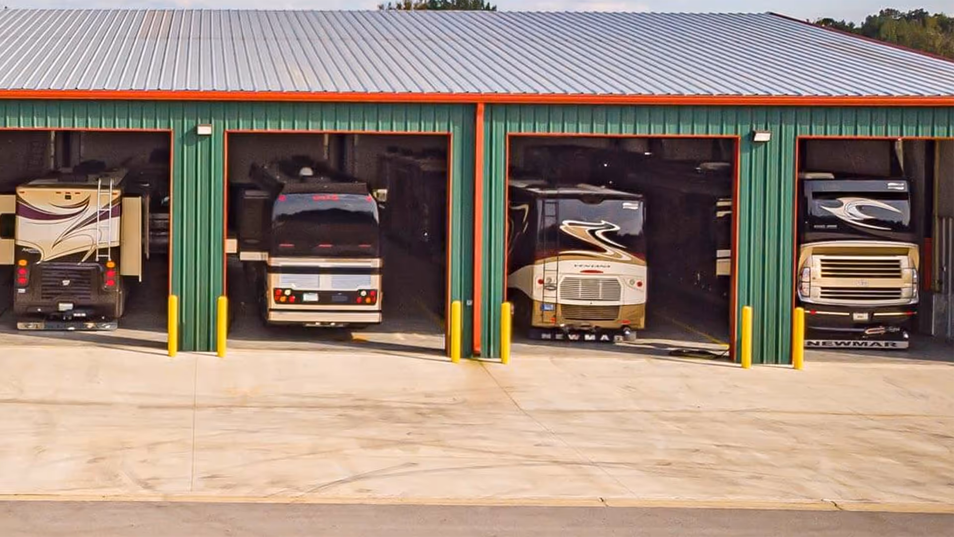 Hawkins Pointe Luxury Storage opened bays with various motorcoaches inside.