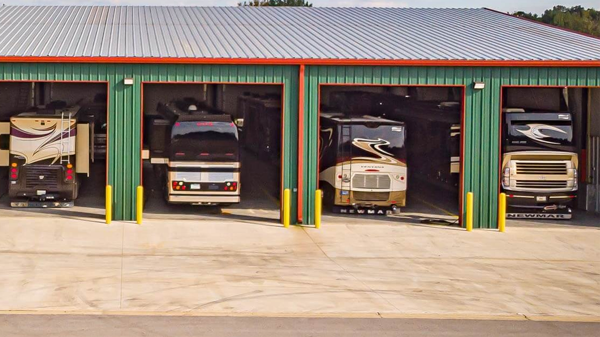Hawkins Pointe Luxury Storage opened bays with various motorcoaches inside.