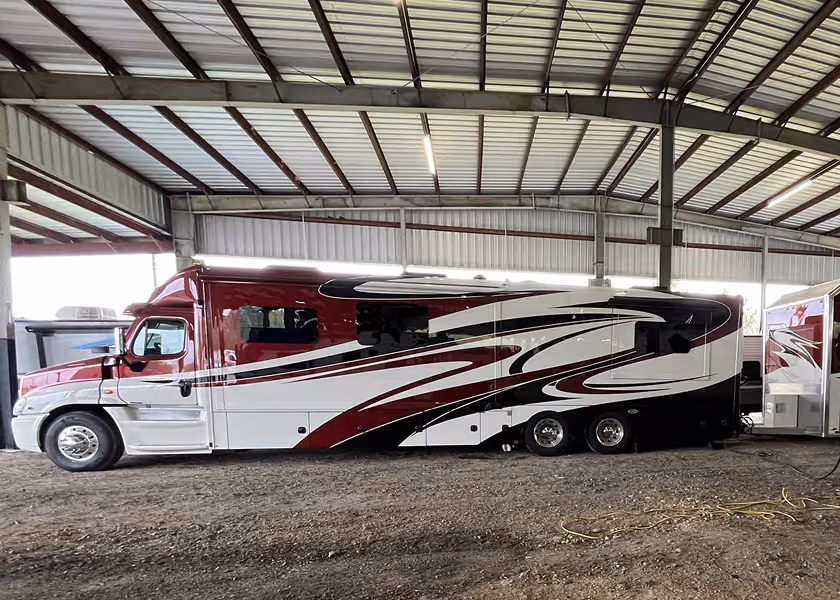  RV technician entering a motorhome with toolbox.