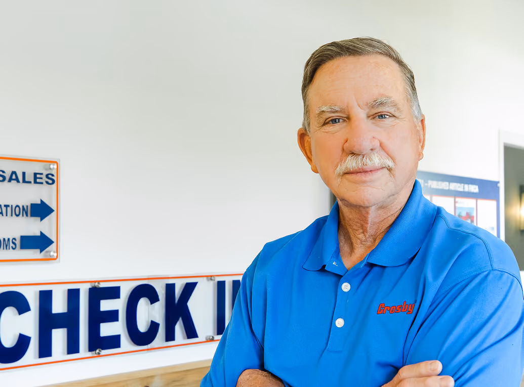 John Hawkins standing in front of Hakwins Pointe Check In sign.