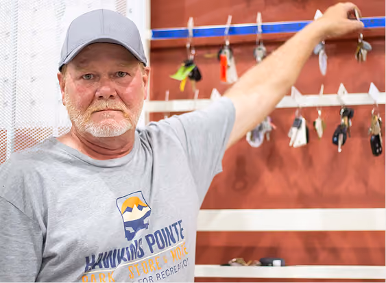 Kevin, Hawkins Pointe Storage Manager, in front of storage keys unit.