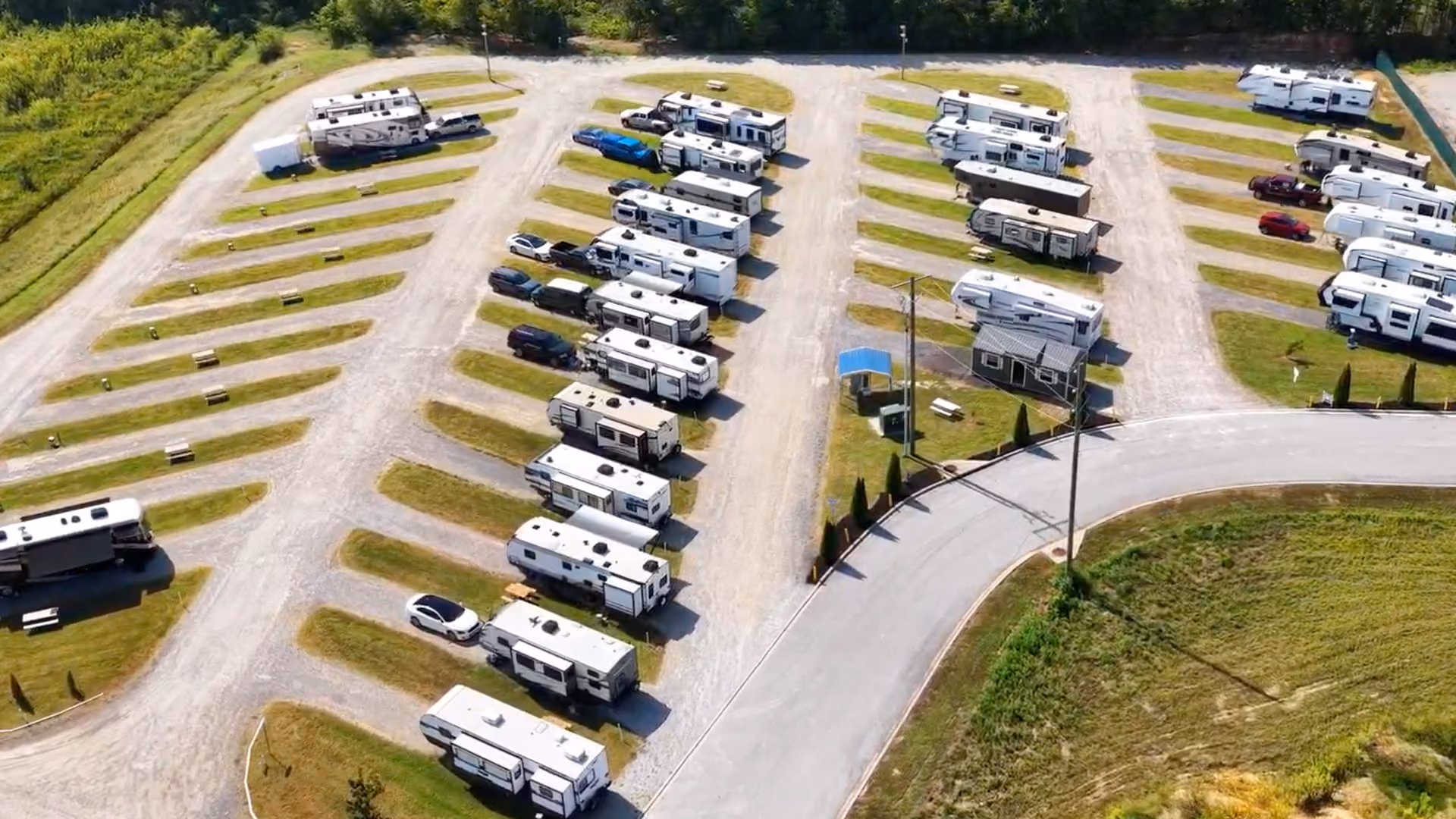 Aerial view of long-term RV storage rows at Hawkins Pointe RV Basecamp with trailers and motorhomes parked on gravel pads.