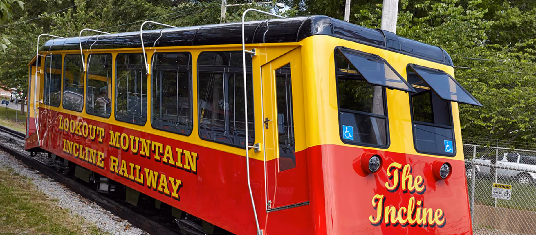 Red and yellow Lookout Mountain Incline Railway trolley car at the lower station.