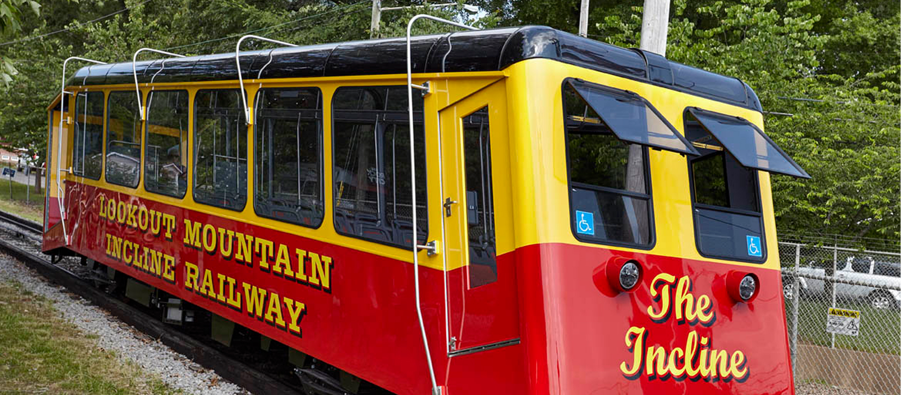 Red and yellow Lookout Mountain Incline Railway trolley car at the lower station.
