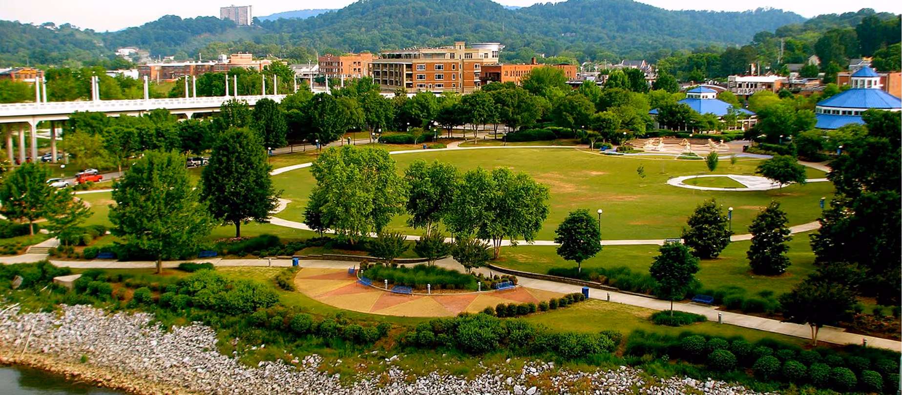 Aerial view of the green lawn and riverfront at Coolidge Park in Chattanooga.