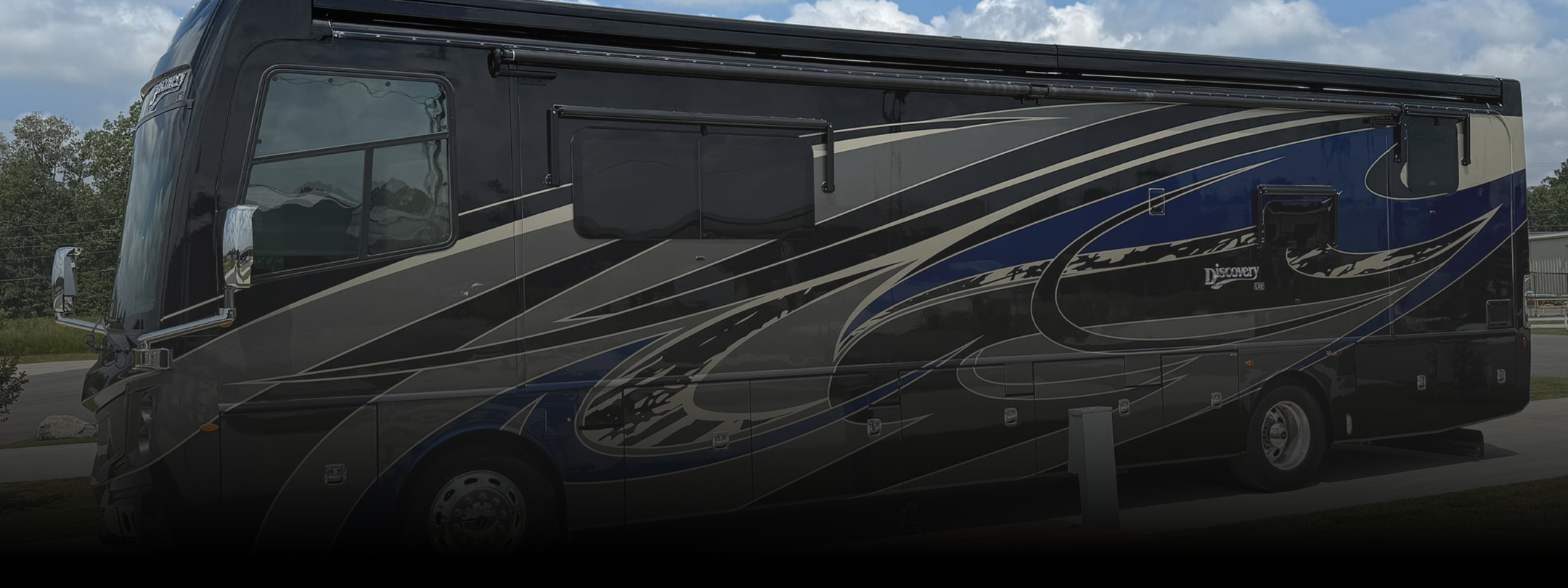 Black, blue, and silver motorhome parked at Hawkins Pointe.