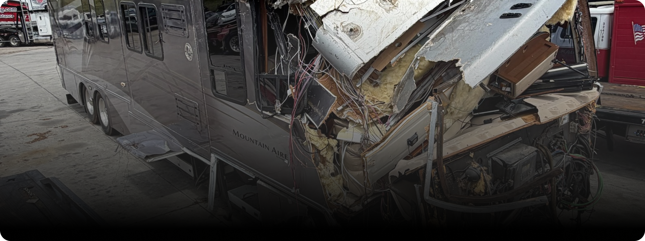 Front section of a motorhome with severe damage after a tire blow in the front.
