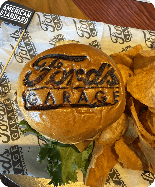 American Standard burger with the Ford's Garage logo branded on the bun.