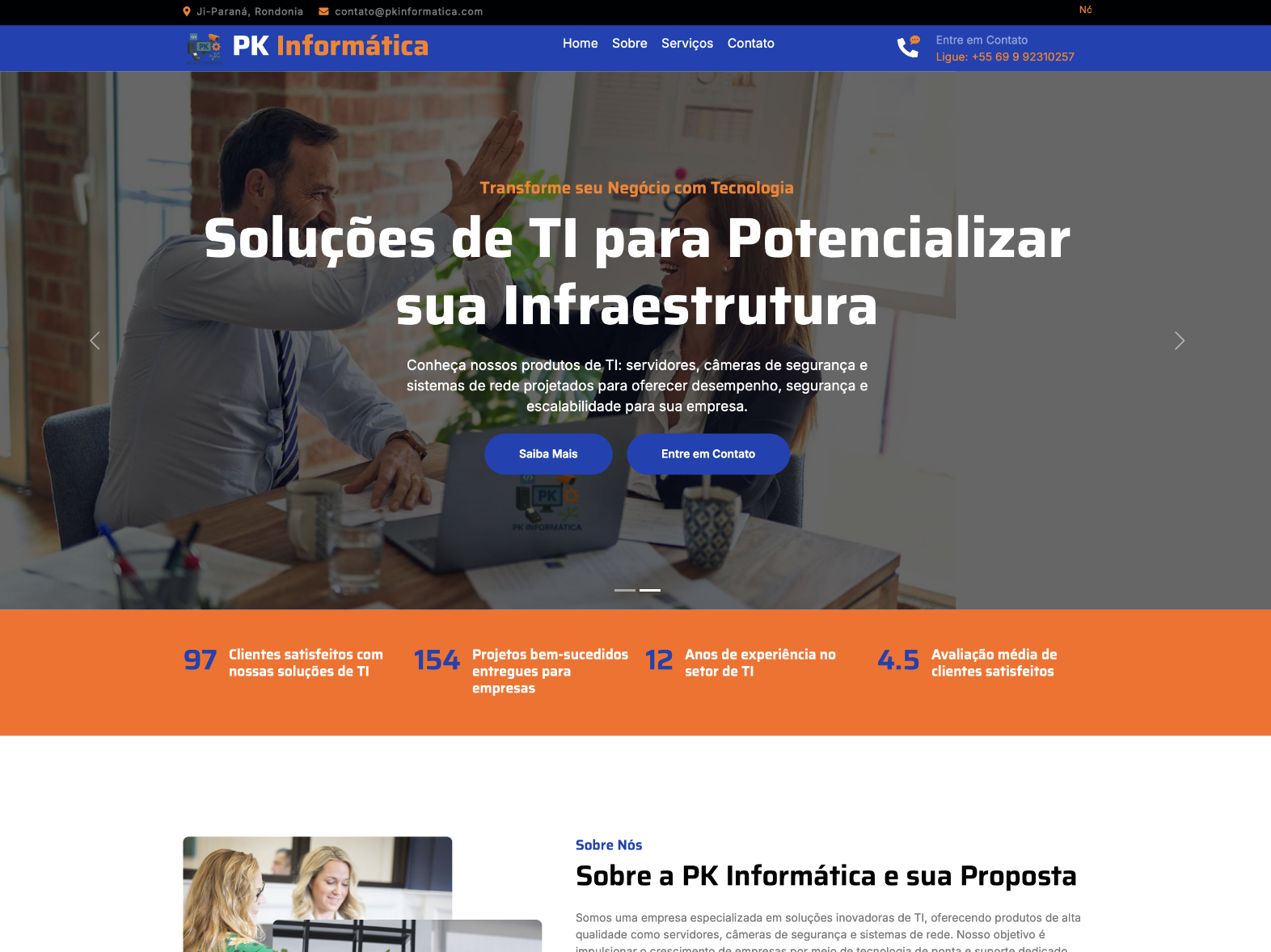 Two business professionals high-fiving at a desk with a laptop and documents, promoting IT solutions to enhance infrastructure.