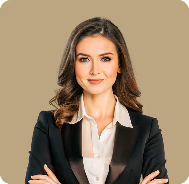 Confident woman with long brown hair wearing a black blazer and white shirt, smiling with arms crossed.