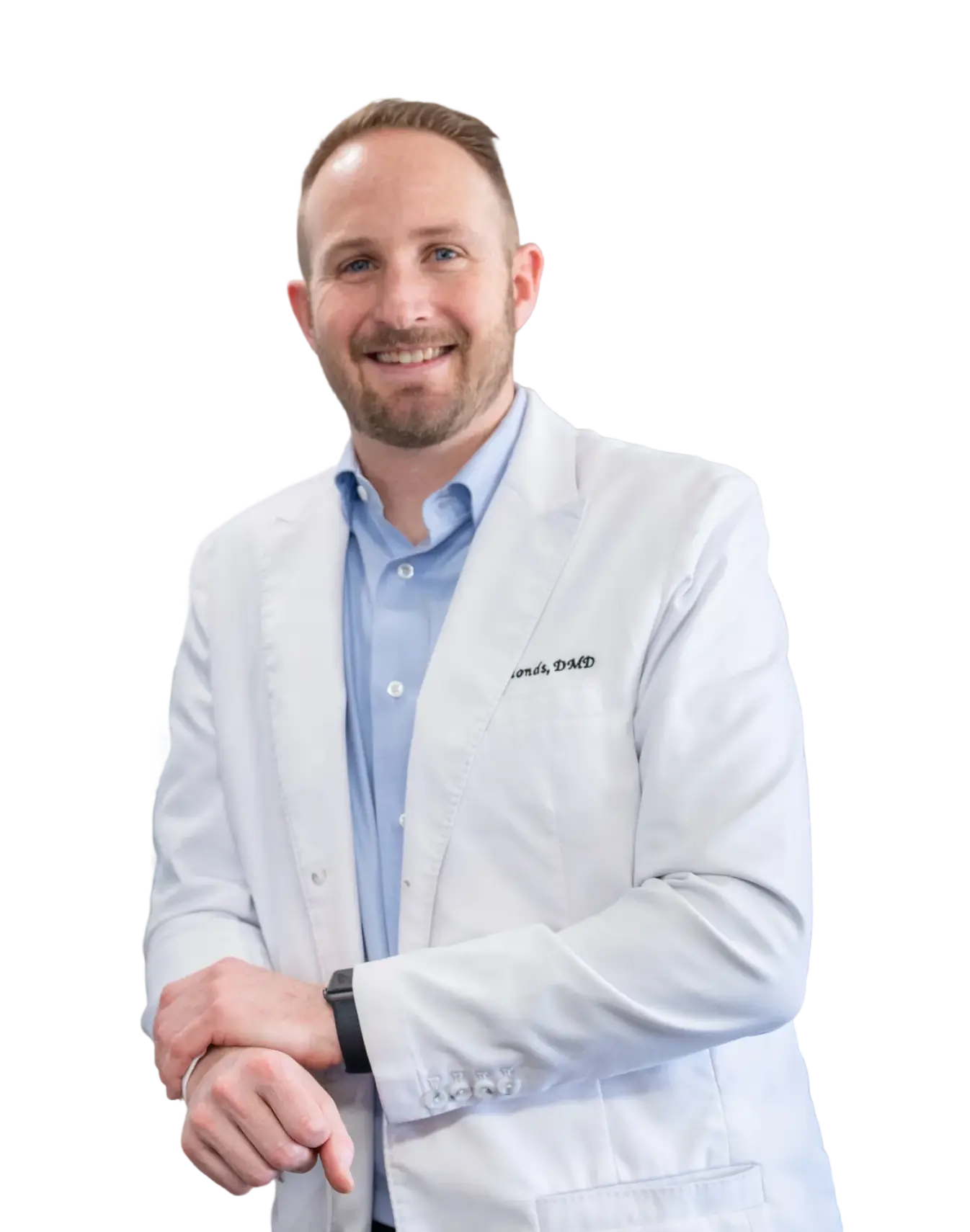 Smiling male dentist in a white coat and light blue shirt wearing a smartwatch.