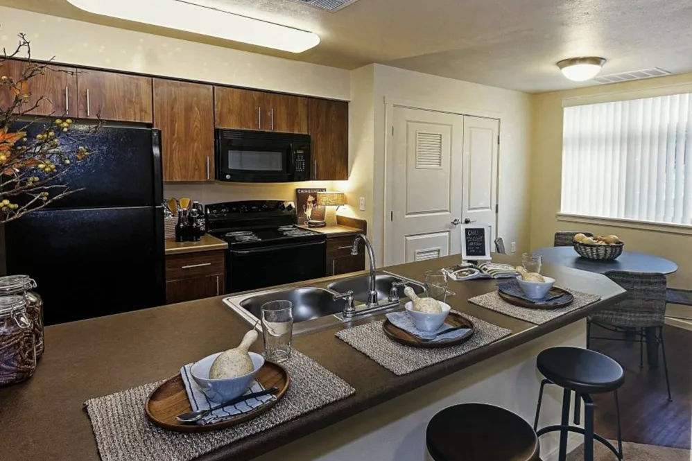 Kitchen with brown cabinet and black appliances