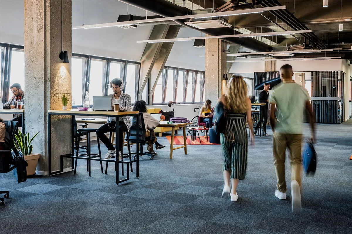 A group of people sitting at a table in an office.