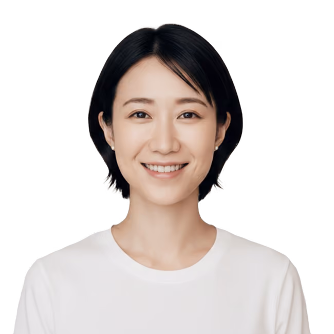 Smiling young woman with short black hair wearing a white shirt against a transparent background.