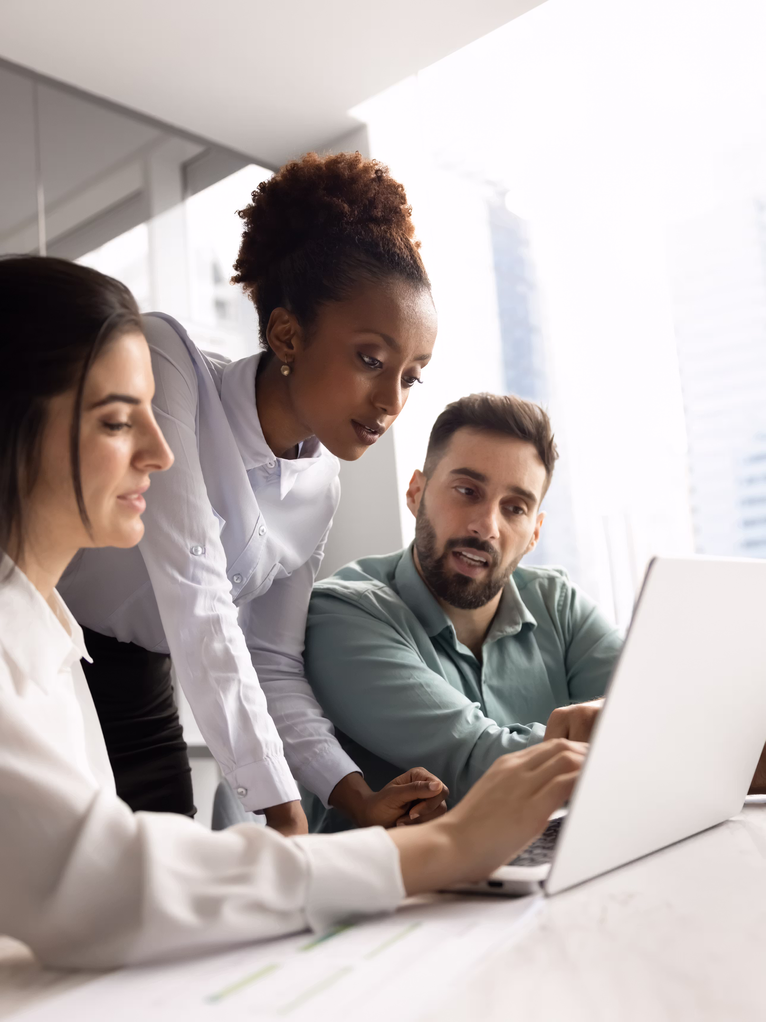 Technology team collaborating on digital work in a modern open-plan office.