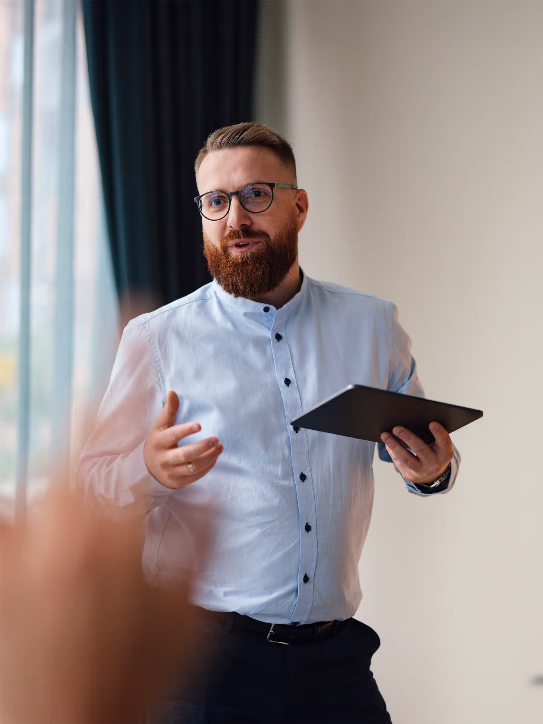 A person pointing to information on a desktop screen
