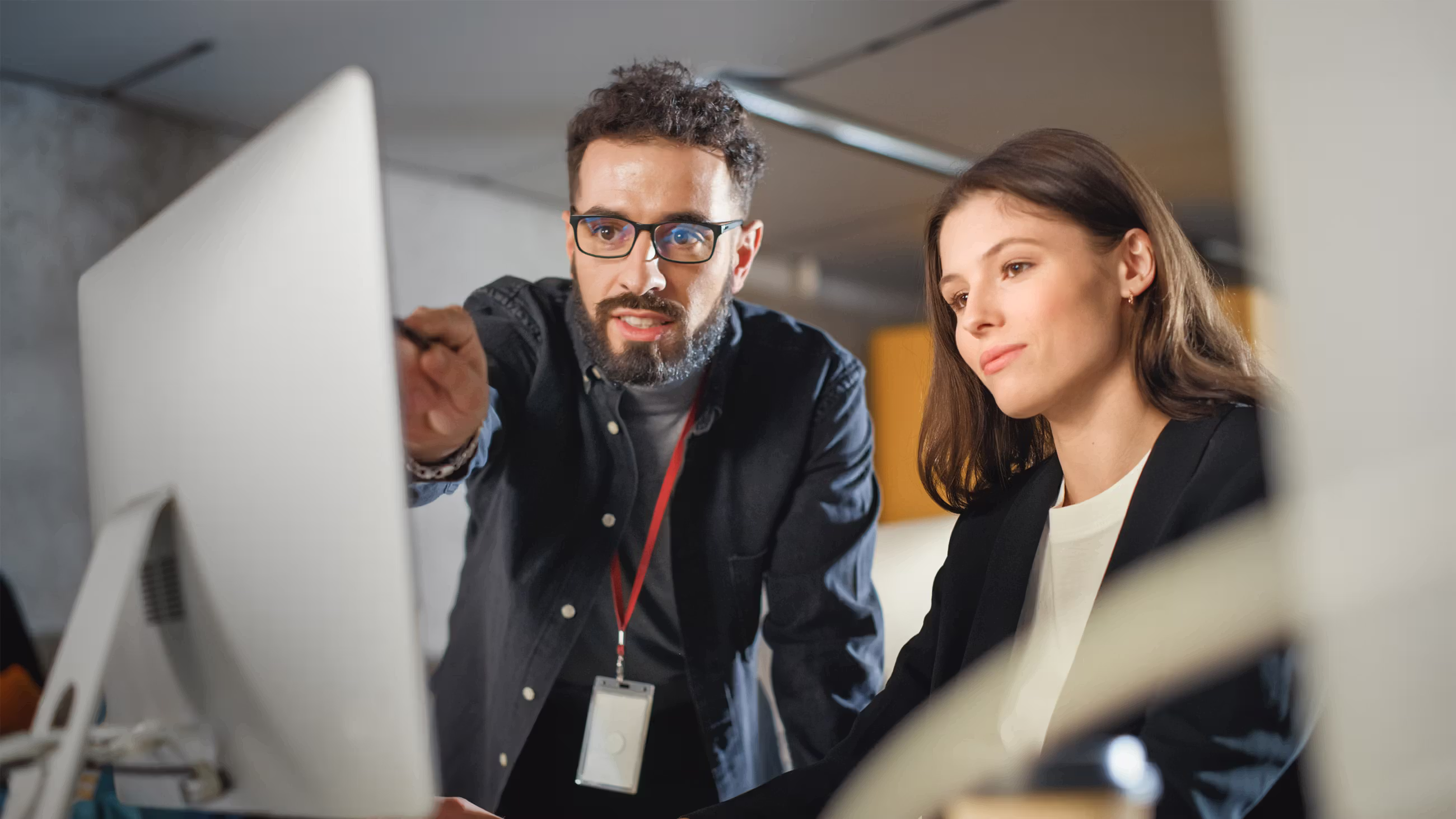 Two team members working together at a computer