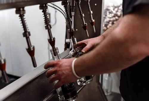 A distiller filling bottles with whiskey at Junction 35 Spirits in Pigeon Forge, Tennessee.