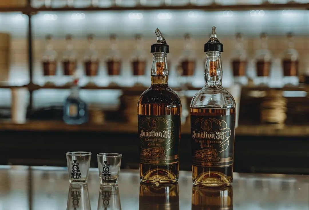Junction 35 Spirit bottles and shot glass sitting on a bar at Junction 35 Spirits in Pigeon Forge, Tennessee.