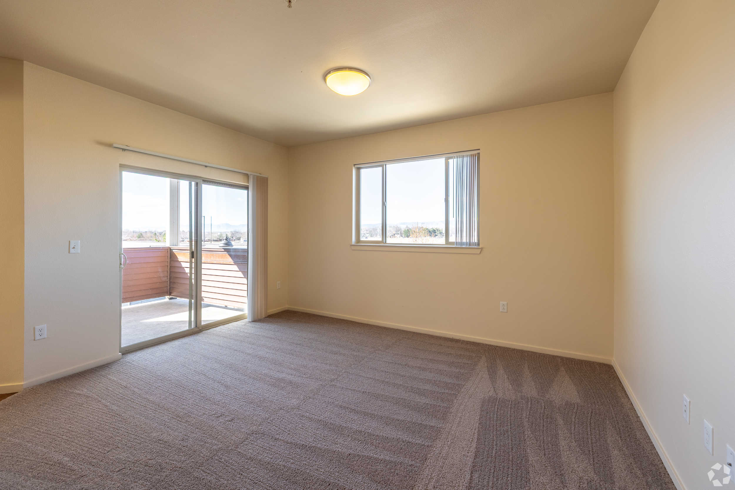 Unfurnished Living area with sliding doors to patio