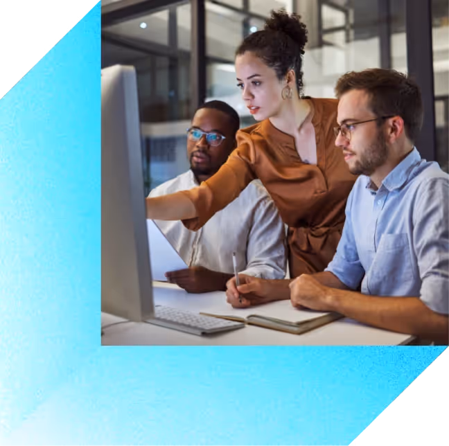 A male and female coworker looking at a computer screen together