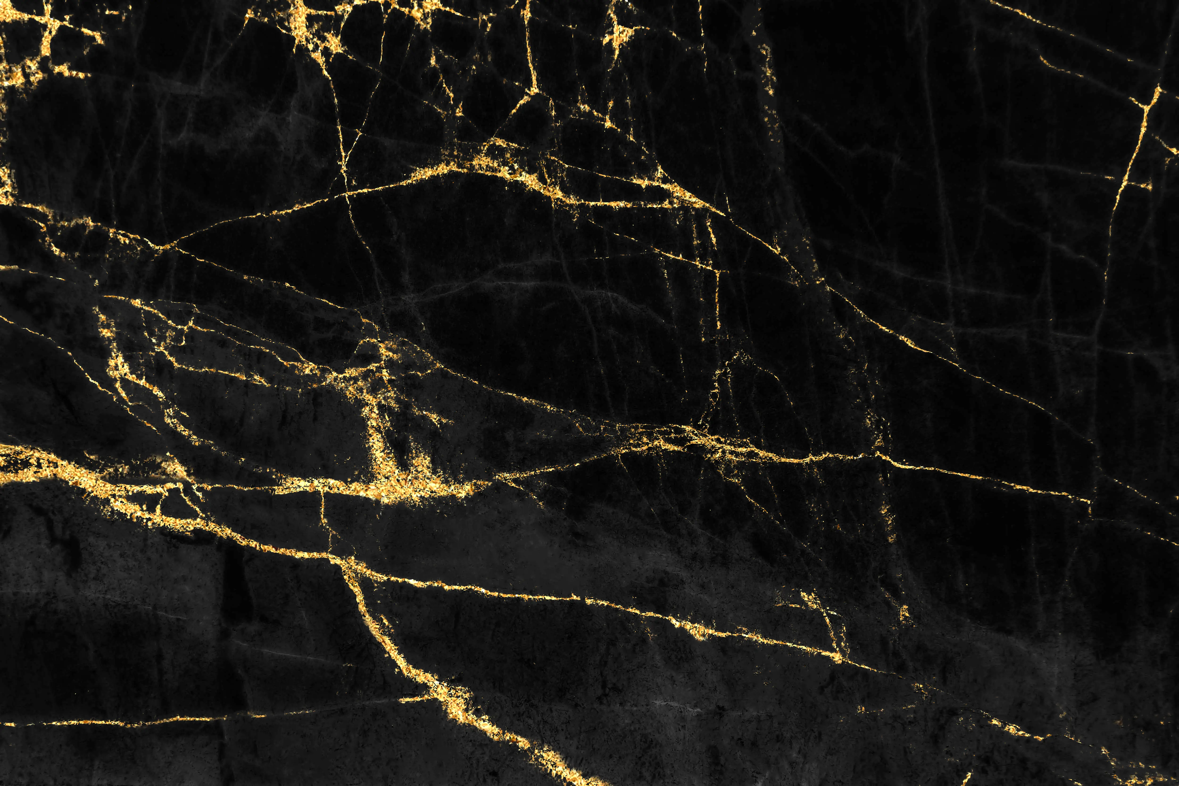 Black marble surface with irregular gold veins creating a luxurious pattern.