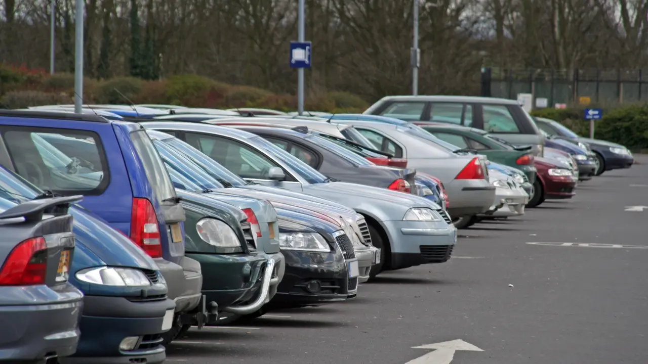 cars parked in a row in a busy car park