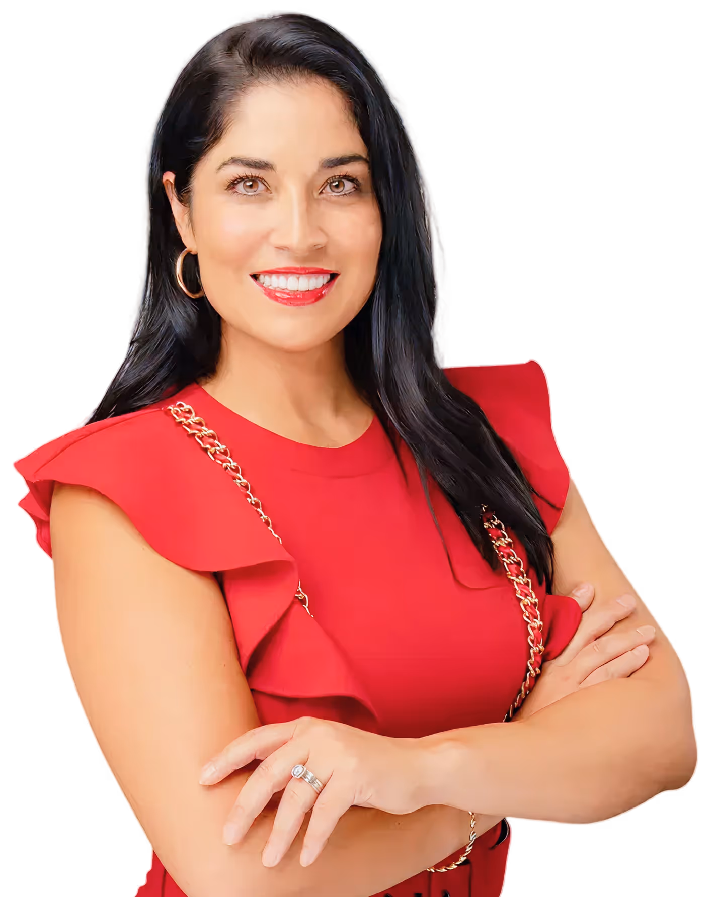 Smiling woman with long dark hair wearing a red dress with ruffled sleeves and gold chain detail, arms crossed.