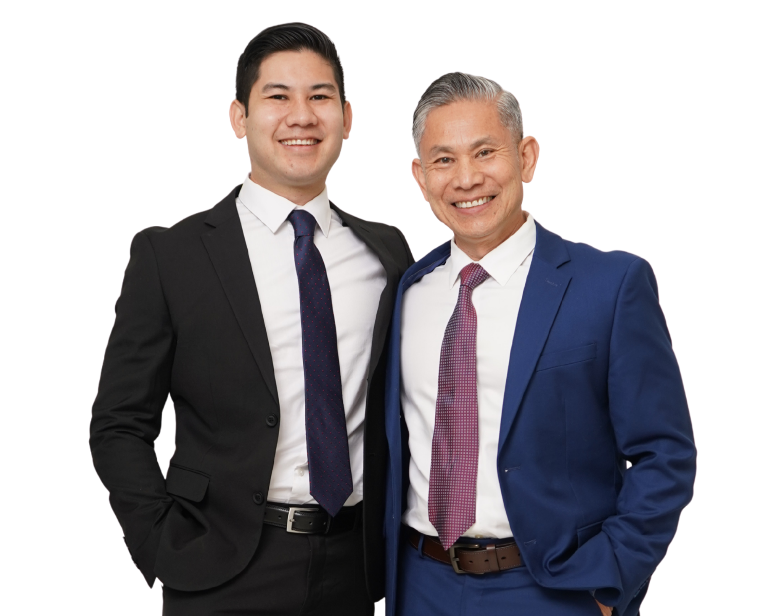 Samee and Nasar smiling and standing side by side wearing business suits, one in black and the other in blue.