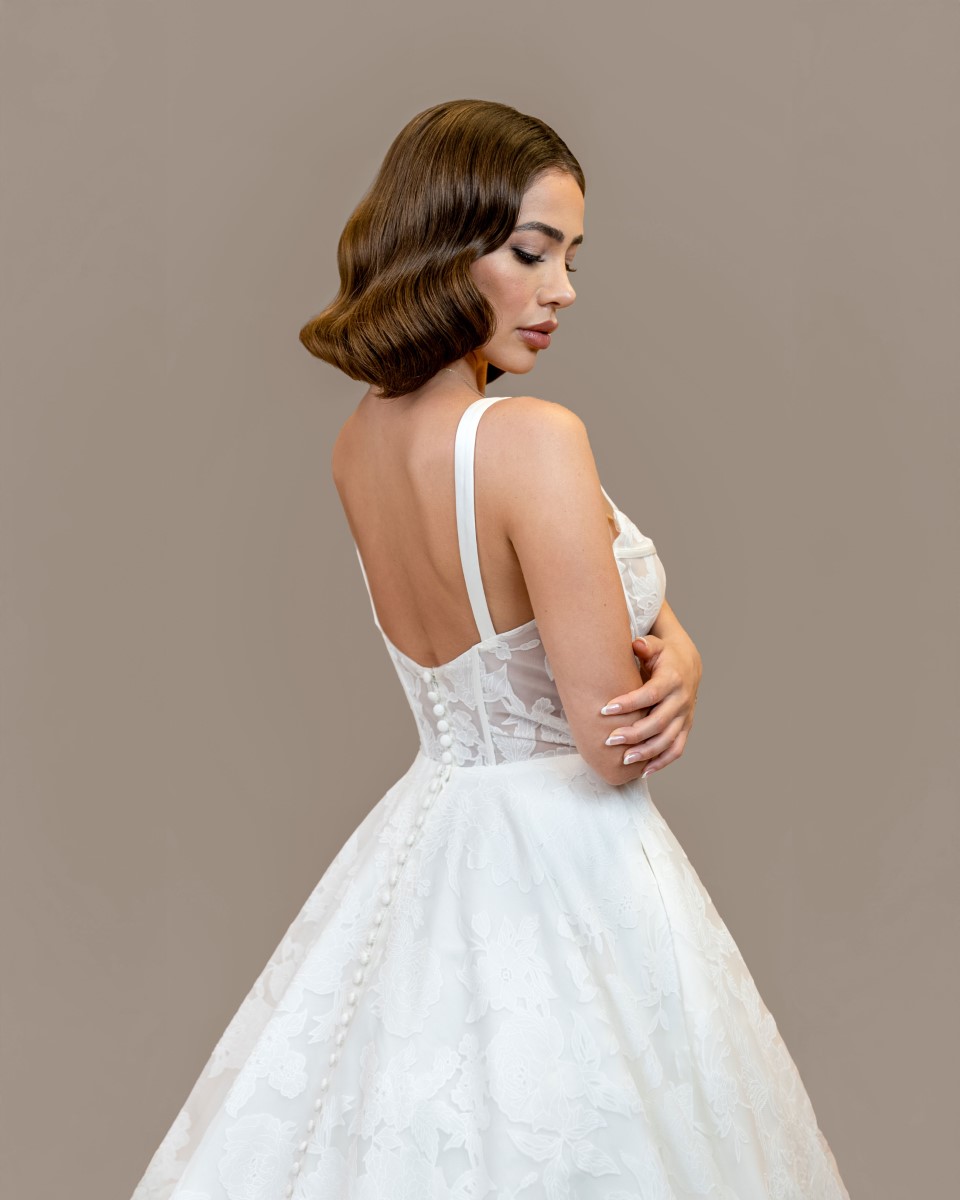 Elegant bride in white gown with glam vintage waves styled by professional hair stylist