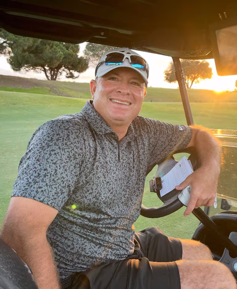 Wynne Baker sitting in golf cart on the golf course