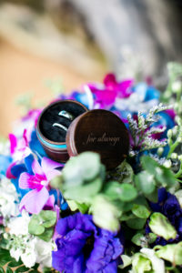 Wedding rings surrounded by flowers.