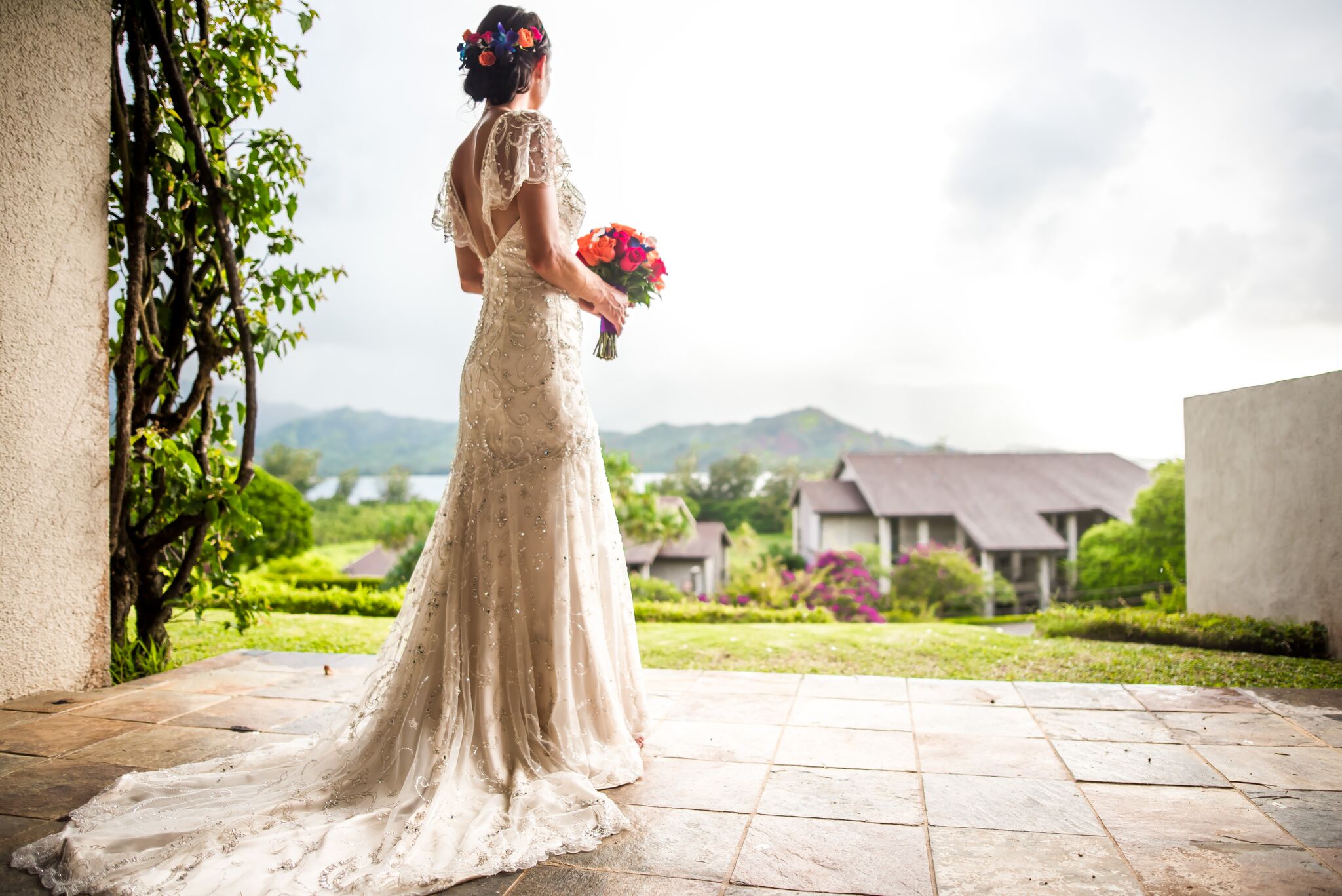 Bride with flowers looking away.