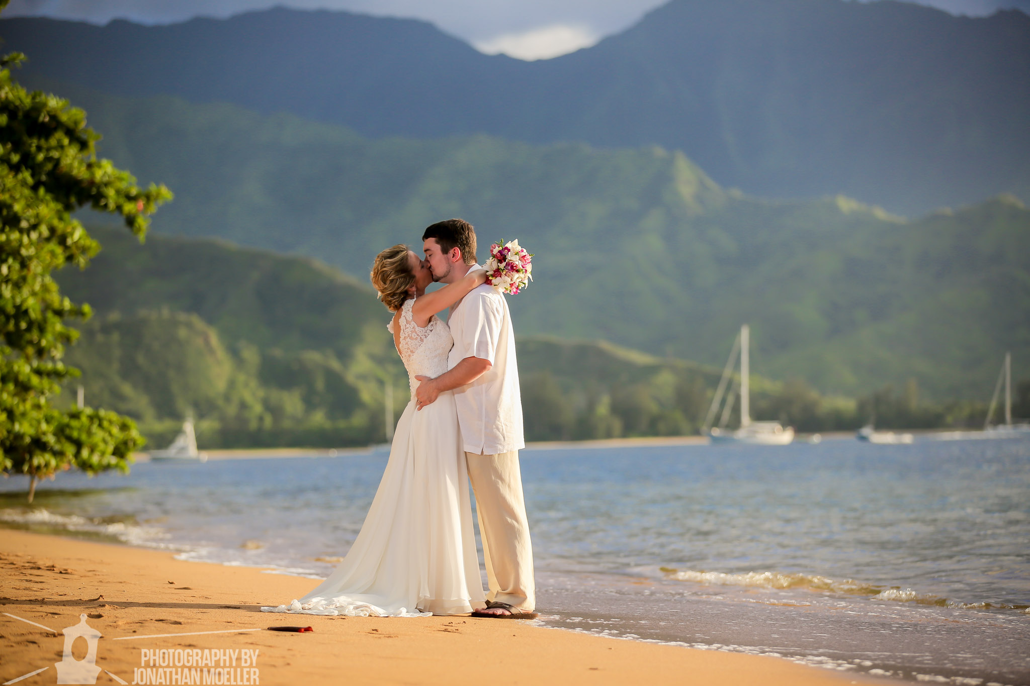Couple embracing on Puu Poa Beach.
