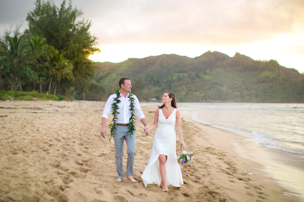 Couple eloping on the beach in Kauai.