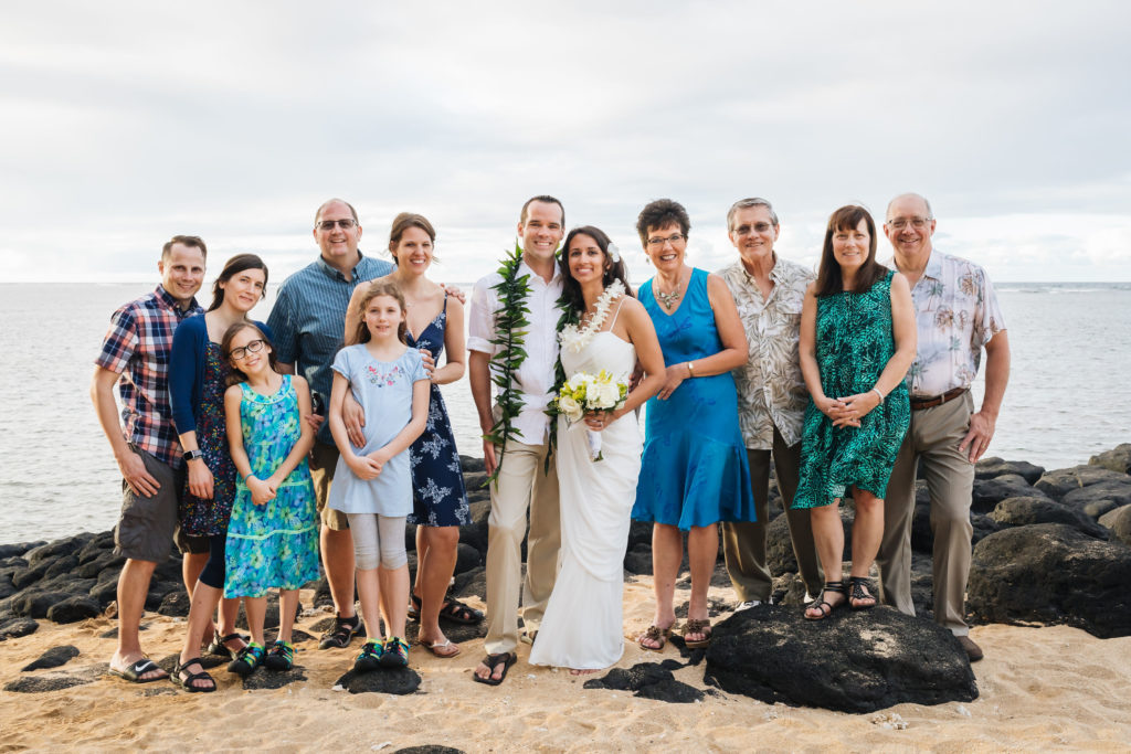 Bride and groom's family on the beach after wedding.
