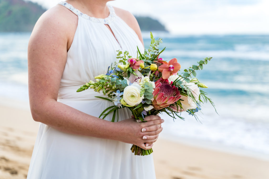 Bride with floral arrangement.