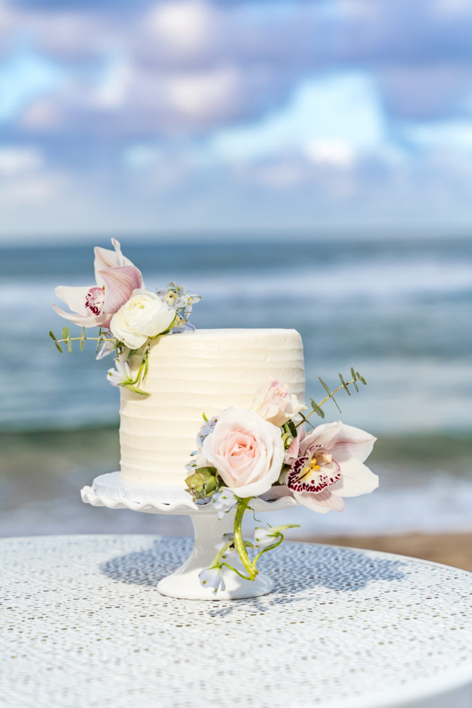 Wedding cake on the beach in kauai.