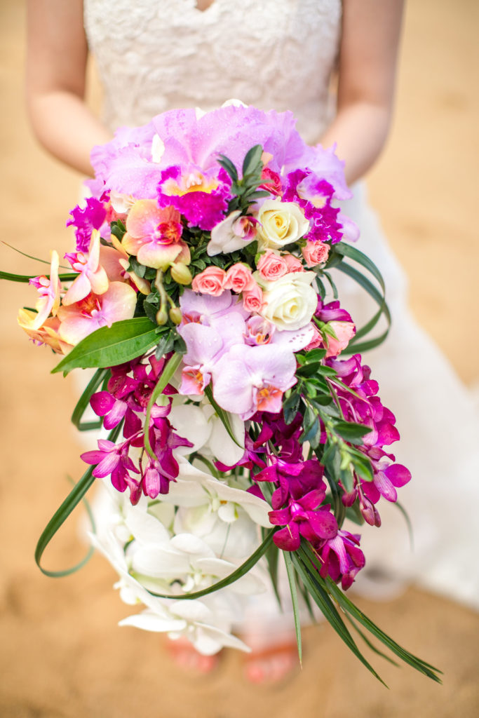 Bride holding flower bouquet.