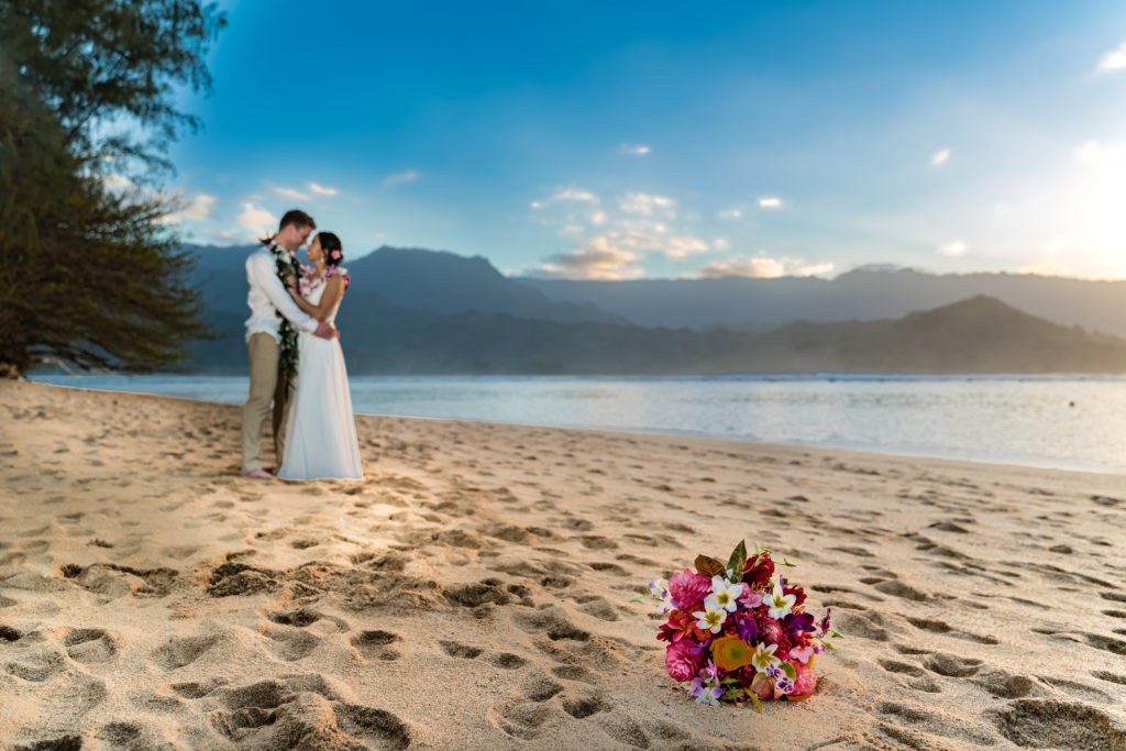 Bride and groom eloping on the beach in Hawaii.