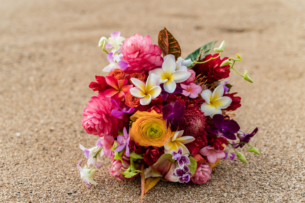 Flower bouquet in the sand on the beach.
