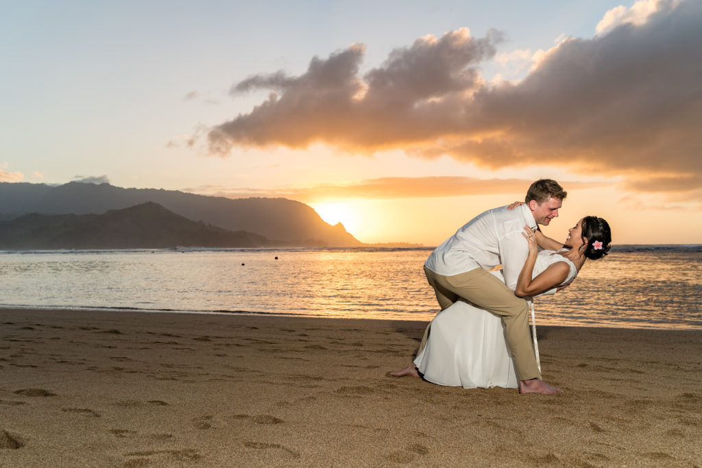 Husband and wife on the beach in Kauai.