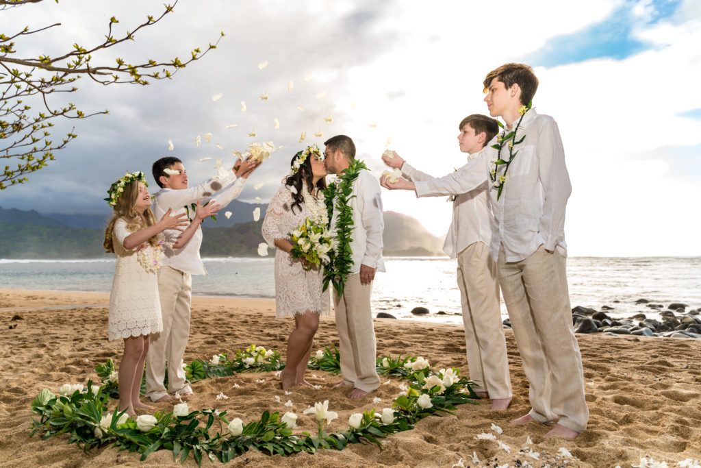 Family on the beach for a wedding in Kauai.