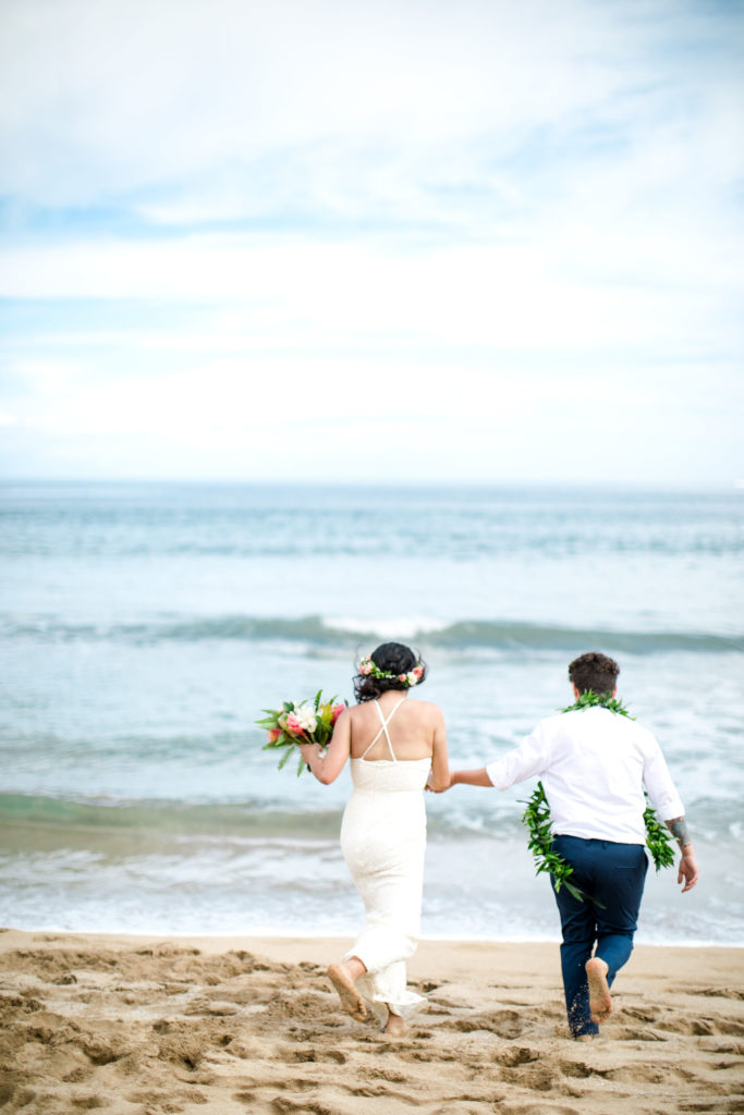 Couple walking on the beach in Kauai.