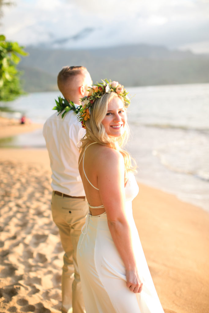 Bride and groom getting married on the beach in Hawaii.