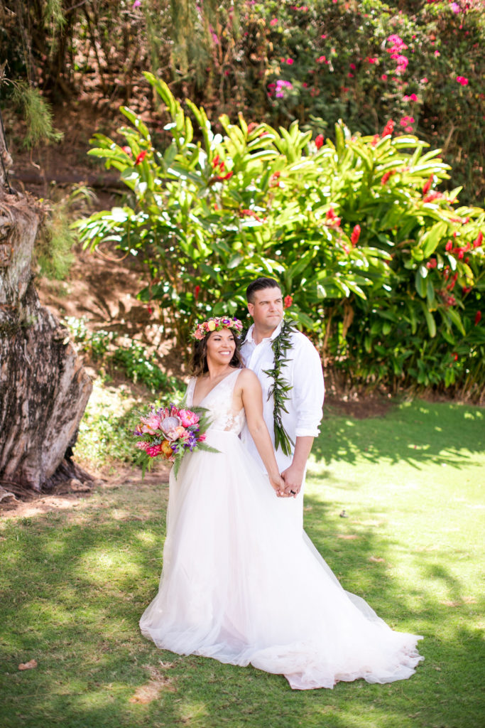 Bride and Groom posing for photos in Kauai.