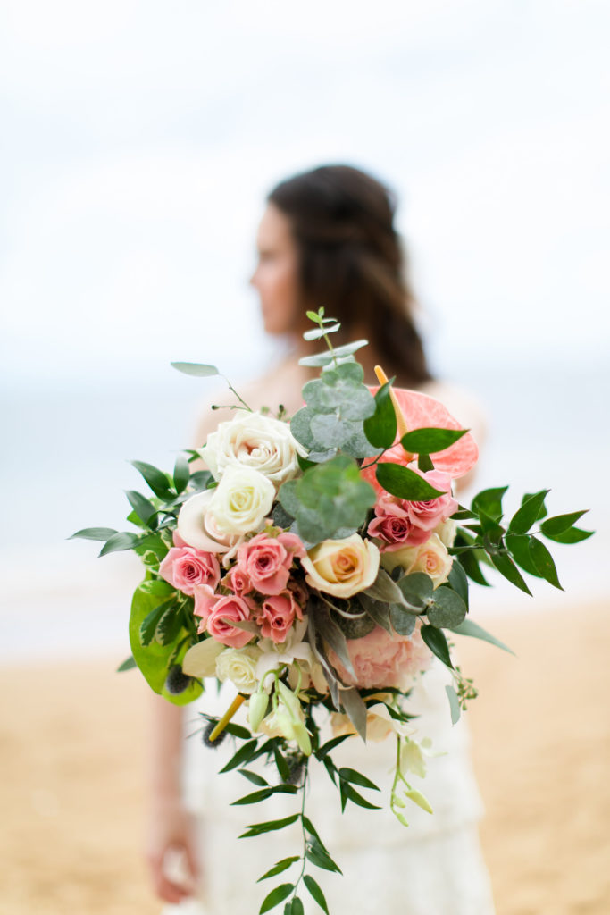 Bride holding flower bouquet.