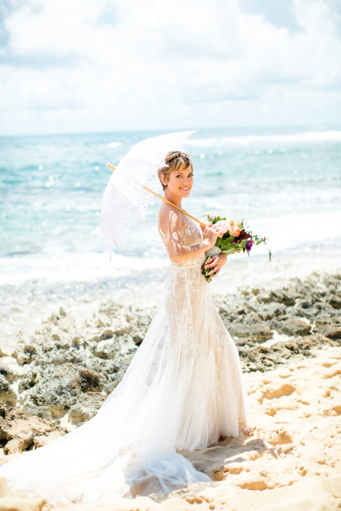 Bride holding flower bouquet.