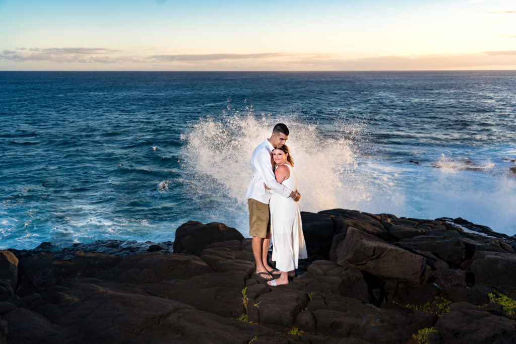Bride and Groom in front of crashing waves in Hawaii.