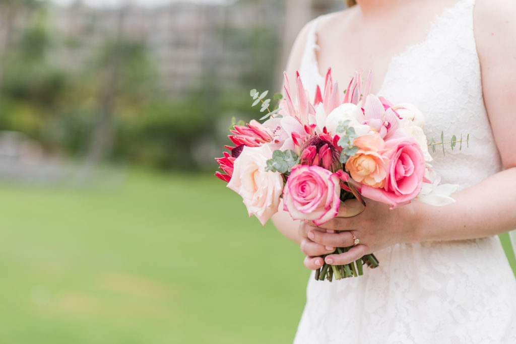 Bride holding flower bouquet.